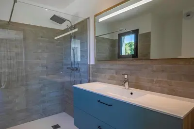 a bathroom with a sink and a mirror at Villa 20 in Sainte-Lucie de Porto-Vecchio
