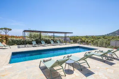 a swimming pool with chairs and a table next to a pool at Villa 20 in Sainte-Lucie de Porto-Vecchio