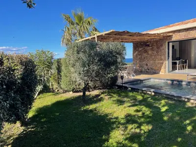 a backyard of a house with a swimming pool at Villa Machja Solenzara in Sari Solenzara