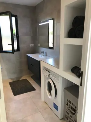 a laundry room with a washing machine and a sink at Villa Machja Solenzara in Sari Solenzara