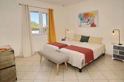 a bedroom with a bed and a chair and a window at Di Felicita in Albitreccia