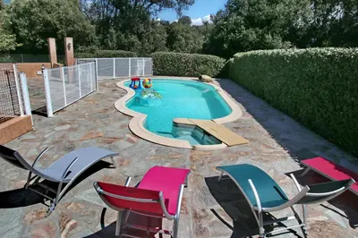 a small swimming pool with chairs and a pool table at Di Felicita in Albitreccia