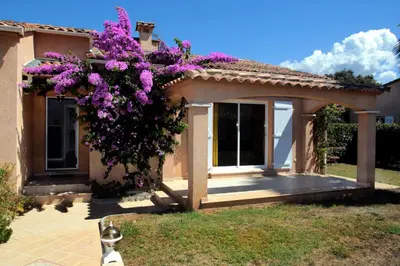 a house with purple flowers on the side of it at Di Felicita in Albitreccia