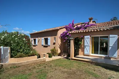 a house with purple flowers on the roof at Di Felicita in Albitreccia