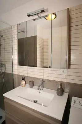 a bathroom sink with a large mirror above it at Studio Di Felicita in Cauro