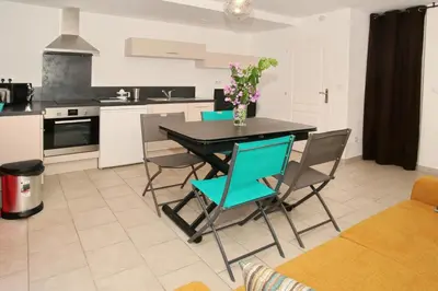 a kitchen with a black table and chairs with flowers on it at Studio Di Felicita in Cauro