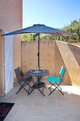 a table and chairs under an umbrella on a patio at Studio Di Felicita in Cauro