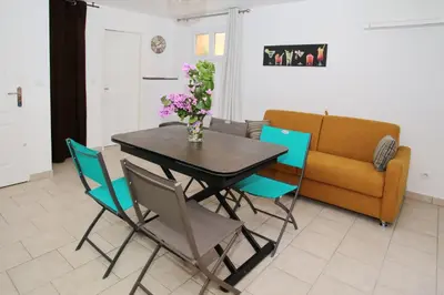 a dining room with a table and chairs and a couch at Studio Di Felicita in Cauro