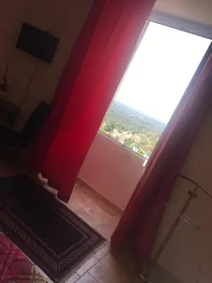 a room with a large window with red curtains at A Balamata in Cervione
