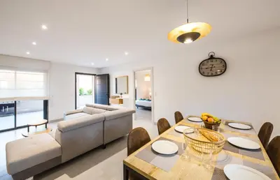 a living room with a table and a couch at Résidence Petra d'Oro - Villa Rondinara in Porto-Vecchio