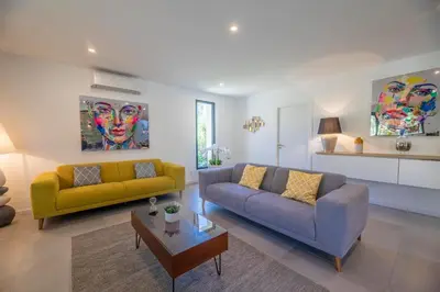 a living room with two couches and a table at Porto Vecchio Villa Bagatelle 8 personnes in Porto-Vecchio
