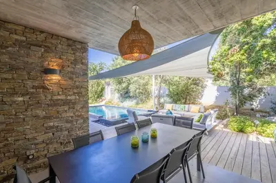 an outdoor dining room with a table and chairs at Porto Vecchio Villa Bagatelle 8 personnes in Porto-Vecchio