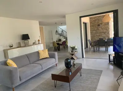 a living room with a couch and a dining room at Porto Vecchio Villa Bagatelle 8 personnes in Porto-Vecchio