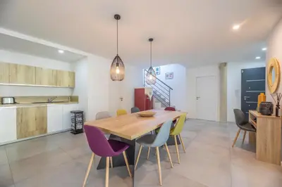 a dining room with a wooden table and purple chairs at Porto Vecchio Villa Bagatelle 8 personnes in Porto-Vecchio