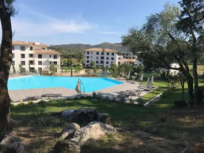 a large swimming pool in front of a building at Résidence de Tourisme 5* Porto Vecchio in Porto-Vecchio