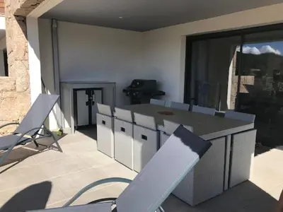 a patio with chairs and a table and a counter at Résidence de Tourisme 5* Porto Vecchio in Porto-Vecchio