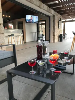 a black table with wine glasses and bottles on it at Résidence de Tourisme 5* Porto Vecchio in Porto-Vecchio