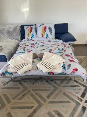 a bed with blankets and pillows on it at Résidence de Tourisme 5* Porto Vecchio in Porto-Vecchio