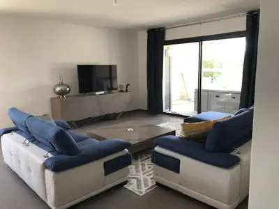 a living room with two couches and a coffee table at Résidence de Tourisme 5* Porto Vecchio in Porto-Vecchio