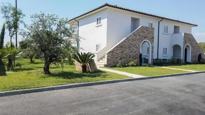 a large white house on the side of a road at A SUARA LINDA in Ghisonaccia