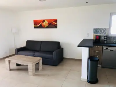 a living room with a couch and a table at A SUARA LINDA in Ghisonaccia