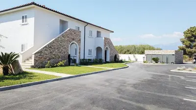 a large white church with a driveway at A SUARA LINDA in Ghisonaccia