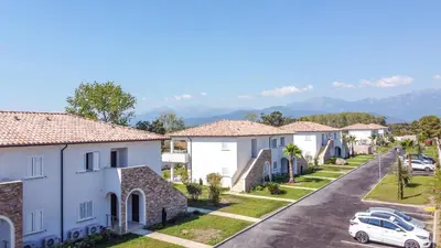 a row of houses in a street with a car at A SUARA LINDA in Ghisonaccia