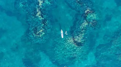 an aerial view of a boat in the ocean at Camping Merendella in San-Nicolao