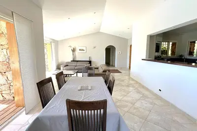 a dining room with a table and chairs at Villa Taglio Rosso Di Santa Lucia in Sainte-Lucie de Porto-Vecchio
