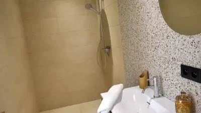 a bathroom with a sink and a shower at Les Villas de Palombaggia in Porto-Vecchio