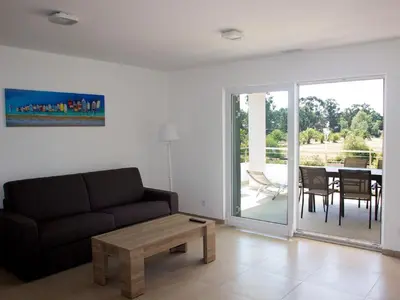 a living room with a couch and a table at Apartment A Suara Linda-2 by Interhome in Ghisonaccia