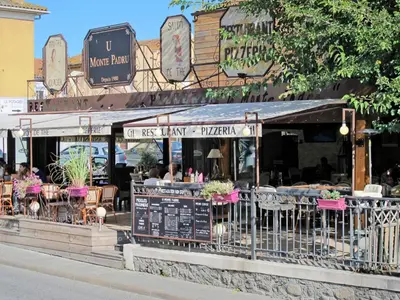 a restaurant with tables and chairs in front of a building at Apartment A Suara Linda-1 by Interhome in Ghisonaccia