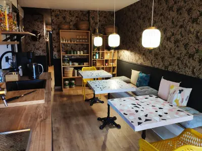 a coffee shop with two tables and a bench at Rosie's Club in Ajaccio