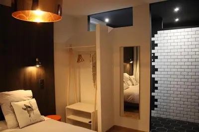 a small bedroom with a bed and a mirror at Rosie's Club in Ajaccio
