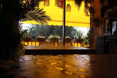 a table in a room with a view of a patio at Rosie's Club in Ajaccio