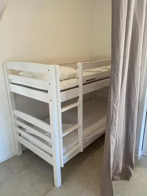 a white bunk bed in a room at Résidence Casarella Lama in Lama
