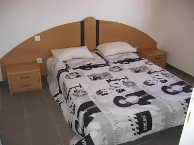 a bedroom with a bed with a black and white comforter at Terrasse de Malbeccu in Casamaccioli