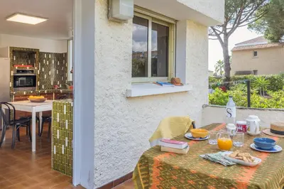 a table with food on it next to a kitchen at Villa Les 3 frères in San-Nicolao