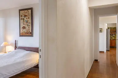 a bedroom with a bed and a hallway at Villa Les 3 frères in San-Nicolao
