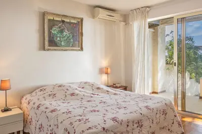 a white bedroom with a bed and a window at Villa Les 3 frères in San-Nicolao