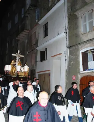 a group of men in black robes standing in front of a building at L'Appart in Bonifacio