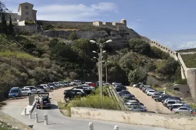 a parking lot with cars parked on a hill at L'Appart in Bonifacio
