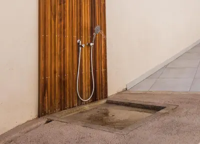 a wooden door with a shower in a room at Résidence Petra d'Oro - Villa Chiappa in Porto-Vecchio