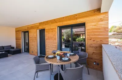 a dining room with a table and chairs at Résidence Petra d'Oro - Villa Chiappa in Porto-Vecchio