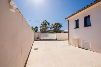 an empty parking lot next to a building at Résidence Petra d'Oro - Villa Chiappa in Porto-Vecchio