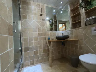 a bathroom with a sink and a shower with a mirror at Chez Marco Gîte & SPA U FILANCIU in Muro