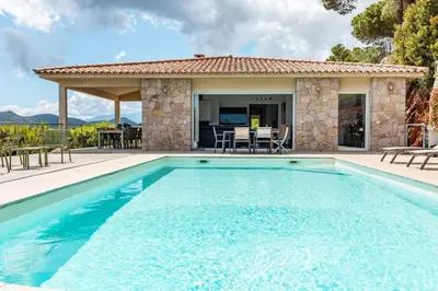 a swimming pool in front of a house at Villa Bella Vista Di Pinarello in Sainte-Lucie de Porto-Vecchio