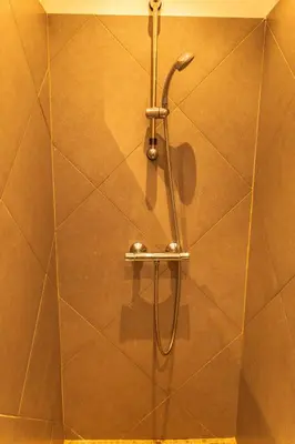 a shower with a shower head in a bathroom at Villa Bella Vista Di Pinarello in Sainte-Lucie de Porto-Vecchio
