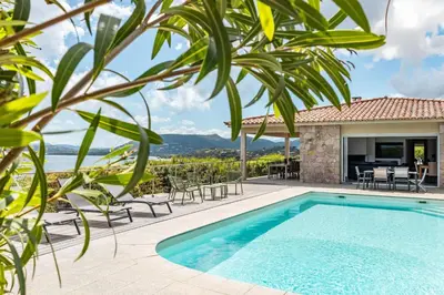 a villa with a swimming pool and a patio at Villa Bella Vista Di Pinarello in Sainte-Lucie de Porto-Vecchio