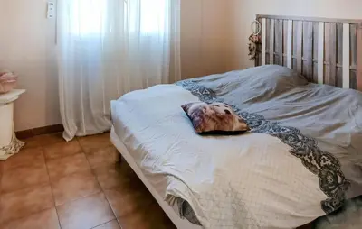 a dog laying on top of a bed at Amazing Home In Borgo With Kitchen in Borgo